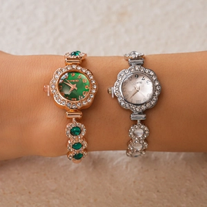 Detail of luxury rhinestone floral quartz watches in gold and silver on woman's wrist