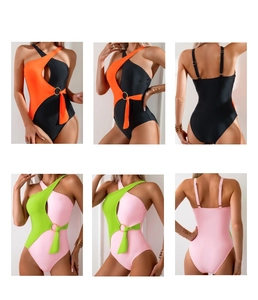 Detail of cutout one-piece swimsuit with color block design and metal ring connector