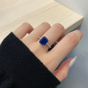 Close-up of a s925 silver ring featuring a blue rectangular gemstone and pavé diamonds