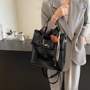 Retro black high-gloss backpack for women with cute brown bear plush charm accessory