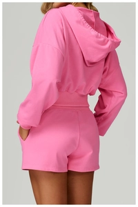 Back view of pink hooded sweatshirt showing ribbed hem and premium cotton fabric texture