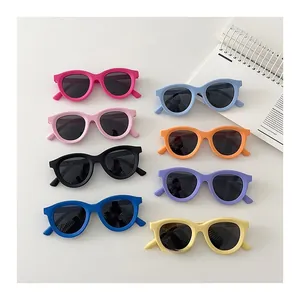 Flat lay of colorful children's polarized sunglasses in eight vibrant matte shades