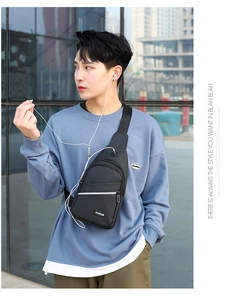 Close-up of black men's chest bag with earphone port and FASHION label for cycling