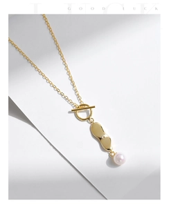 Detailed view of s925 silver necklace with OT clasp, geometric charm, and pearl