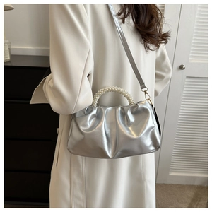 Silver metallic pleated cloud bag with pearl handle and detachable crossbody strap
