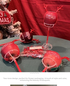 Detail showing red reindeer antler holders for Christmas apple DIY floral decoration