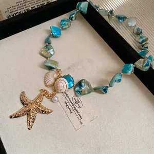 Starfish and seashell charm necklace with blue-green stones for beach vacation style