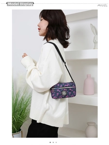 Detail of oxford nylon crossbody bag featuring purple cherry blossom wave pattern and strap