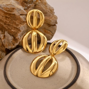 Exaggerated 18k gold plated stainless steel hollow spherical earrings on ceramic base