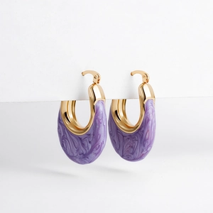 Close-up of gold U-shaped earrings featuring purple marble enamel inlay and polished finish