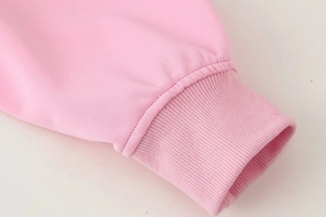 Close-up of pink bomber jacket showing high-quality ribbed cuff detail and stitching