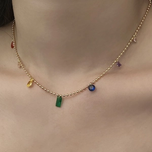 Colorful geometric gemstone necklace with gold beaded chain and multi-colored crystals