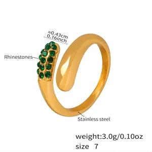 Detail of gold teardrop open ring with micro-paved green rhinestones and polished finish
