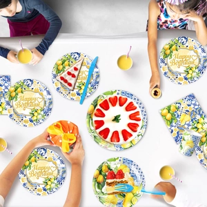 Detail of lemon birthday party tableware with happy birthday plates and citrus pattern
