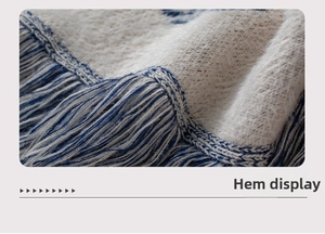 Macro detail of knit sweater hem showing premium mohair texture and fringe tassels