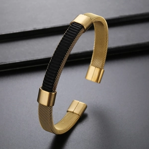 Detailed close-up of a men's gold stainless steel braided mesh bracelet with black accent