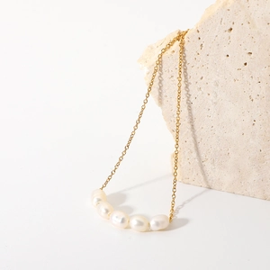 Detail of 18K gold plated necklace featuring five natural freshwater baroque pearls