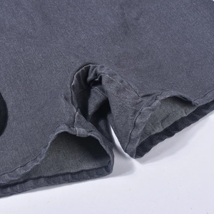 Detail shot of the twin-needle flat seam and dark gray denim fabric on this romper