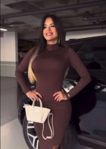 Slim fit dark brown long sleeve bodycon dress with high neck shown in a street style view