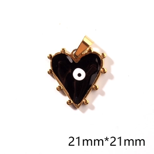 Detail view of 21mm heart-shaped gold pendant with black enamel and evil eye motif