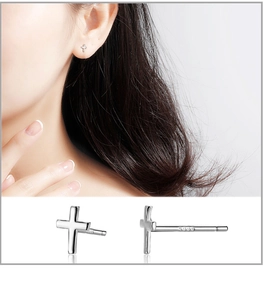 Close-up of S999 sterling silver cross stud earrings with hallmark detail and model view