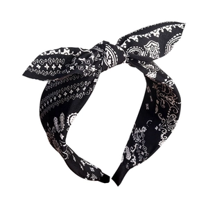 Classic black and white paisley print headband featuring a stylish top knot bow design