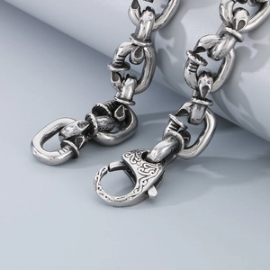 Close-up of industrial style stainless steel square link chain with spring ring clasp