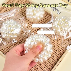 Colorful pearl squishy toy for stress relief shown on a Japanese bamboo tray