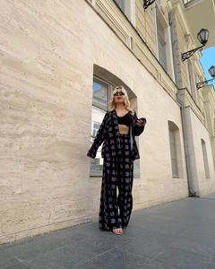 Outdoor street view of a black two-piece lounge set with abstract white prints