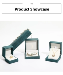 Detailed view of dark green velvet jewelry boxes with soft white lining for rings and necklaces