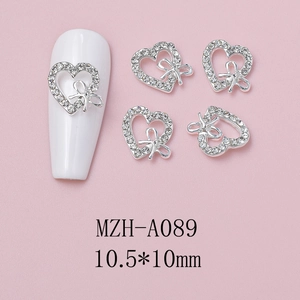Detailed silver heart nail charm with bow and rhinestones, size 10.5x10mm closeup