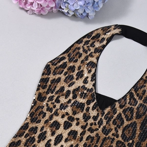 Macro detail of high-density leopard print sequins and neat stitching on a halter top