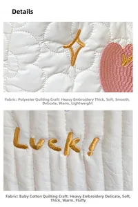 Close-up of fresh quilted canvas tote bag with gold star and Luck embroidery details