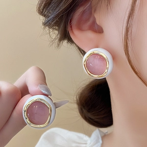 Elegant gold-plated round stud earrings with pink cat-eye stone and white enamel finish
