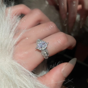 Macro detail of an elegant silver-toned flower ring with a large lavender zircon stone