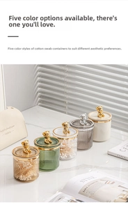 Five assorted colors of vertical ribbed cotton swab jars with bear-shaped lids on a desk