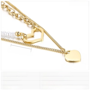 Close-up of double-layered heart pendant necklace with pearls and stainless steel chains
