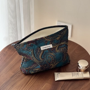Retro paisley jacquard makeup bag with gold floral patterns and simple wish woven label