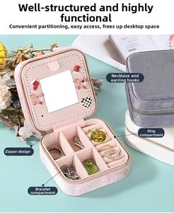 Close-up of pink velvet jewelry box showing mirror hooks and ring storage compartments
