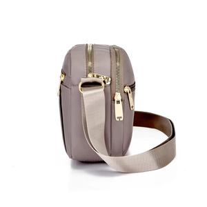 Light khaki nylon crossbody bag for women featuring multiple gold zipper compartments