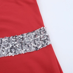 Close-up of sparkling silver sequins stitched on red fabric for a luxury evening dress