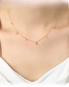 Elegant gold titanium necklace featuring alternating rectangular metal plates and cubic zirconia
