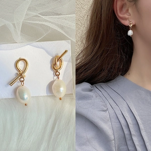 Elegant gold twist earrings with white baroque freshwater pearls shown on model and card