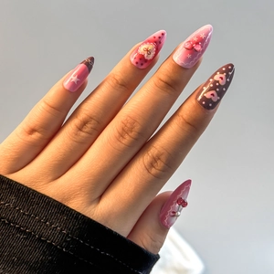 Almond-shaped Valentine's Day press-on nails with sweet pink heart and cherry patterns