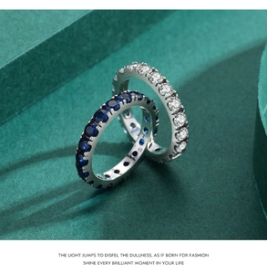 Close-up of S925 sterling silver eternity rings with blue and white zircon stones