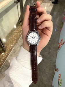 Detailed close-up of PARO quartz watch featuring white textured dial and brown leather strap