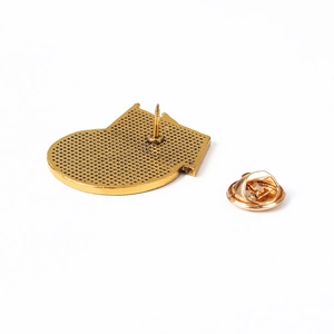 Detail view of the metal medal back with secure gold butterfly clasp and pin fastener