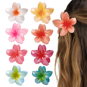 8cm colorful plumeria flower hair claws in multiple colors shown on a model