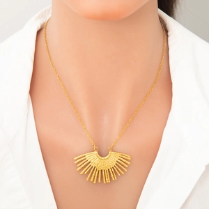 Elegant 18k gold plated stainless steel necklace with sunburst pendant on a female model