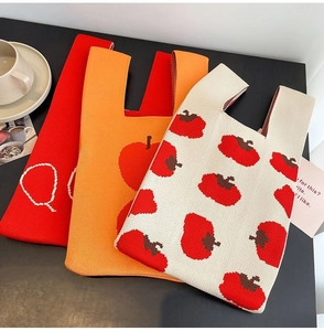 Detailed knit texture of cartoon tote bags in red, orange, and apple pattern style
